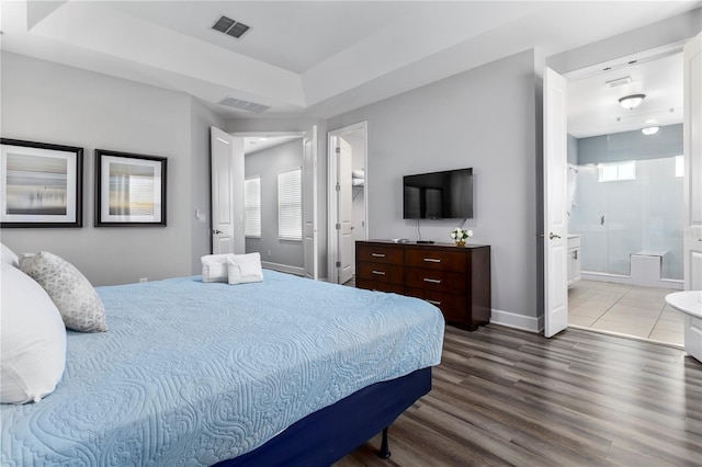 bedroom with wood-type flooring and ensuite bathroom