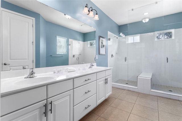 bathroom featuring tile patterned flooring, vanity, and a shower with shower door