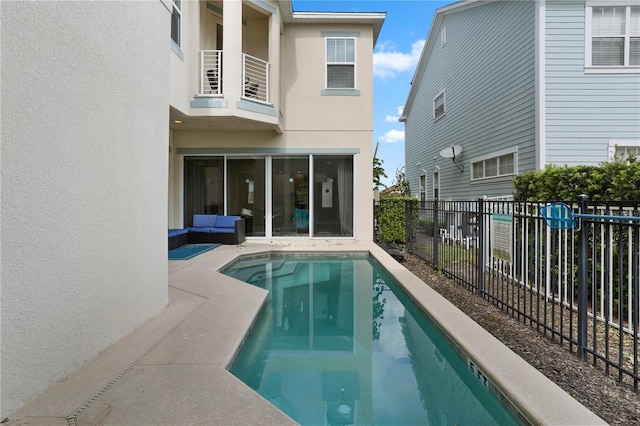 view of pool with a sunroom and a patio area