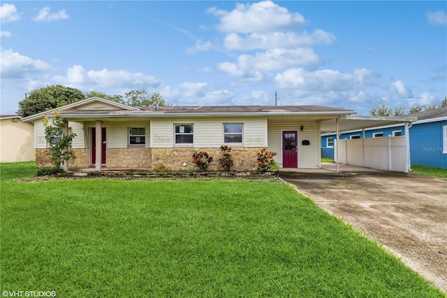 ranch-style house featuring a carport and a front lawn