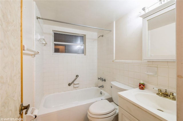 full bathroom featuring vanity, tile walls, toilet, and tiled shower / bath