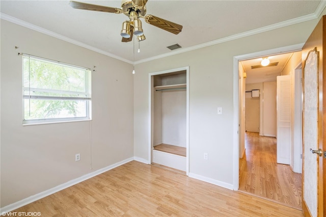 unfurnished bedroom with a closet, ornamental molding, light wood-type flooring, and ceiling fan