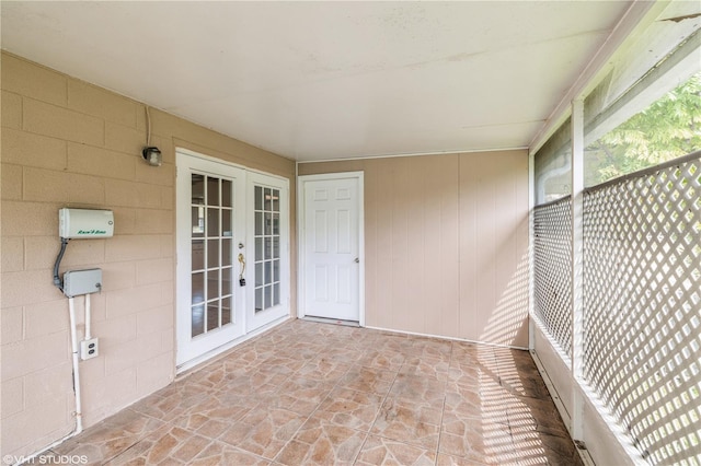 unfurnished sunroom with french doors