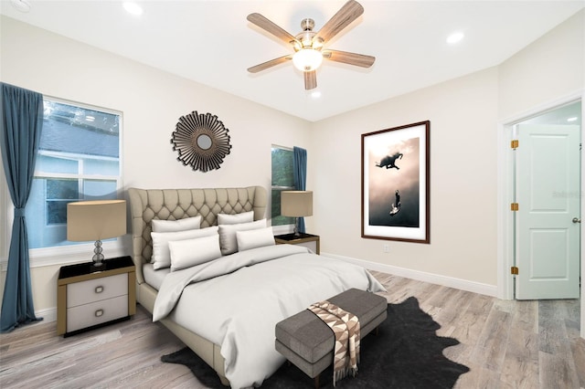 bedroom with light hardwood / wood-style floors and ceiling fan