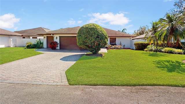 single story home featuring a front lawn and a garage