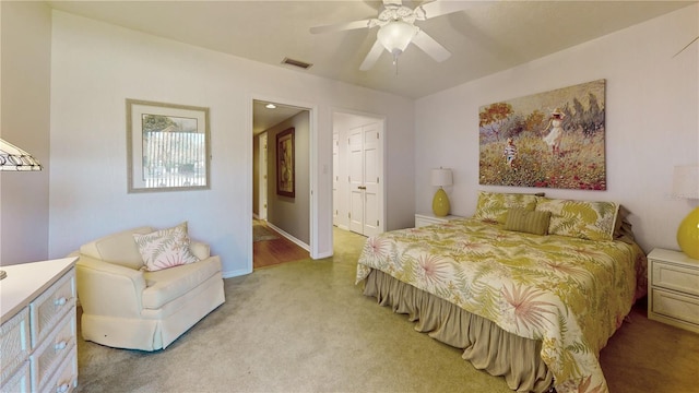 bedroom with light carpet and ceiling fan