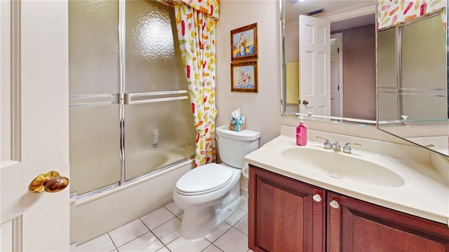 full bathroom featuring toilet, vanity, shower / bath combination with glass door, and tile patterned flooring