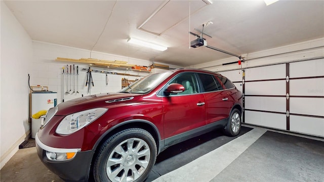 garage featuring a garage door opener and electric water heater