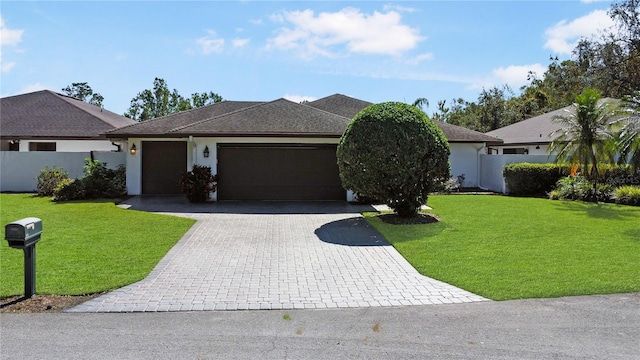 view of front of house with a front yard and a garage