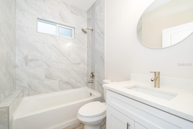 full bathroom featuring vanity, toilet, and tiled shower / bath combo