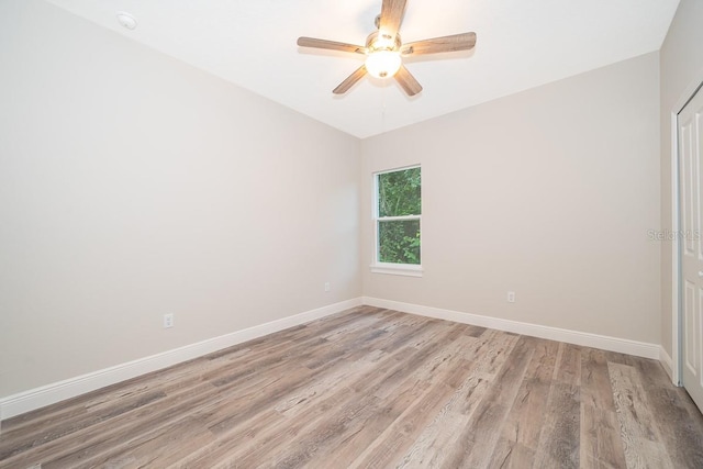 spare room with light hardwood / wood-style floors and ceiling fan