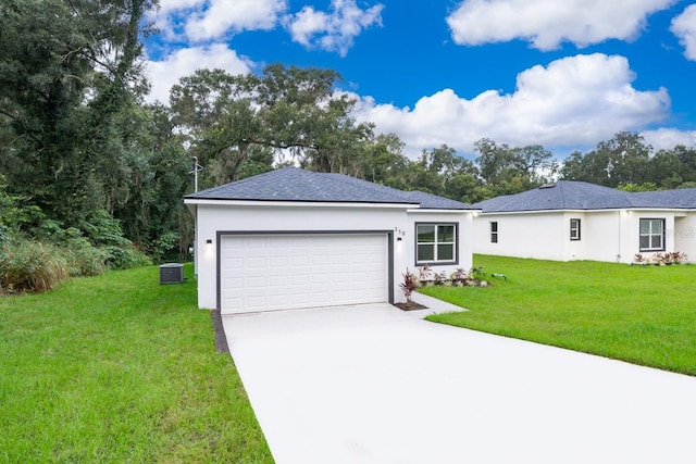 ranch-style house featuring a garage, cooling unit, and a front yard