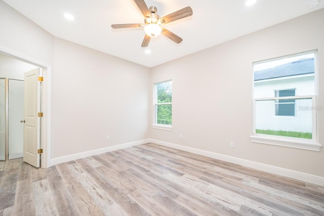 spare room featuring light hardwood / wood-style floors and ceiling fan