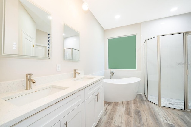 bathroom with vanity, wood-type flooring, and shower with separate bathtub