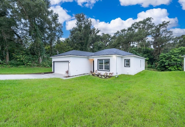 view of front of house with a front yard and a garage