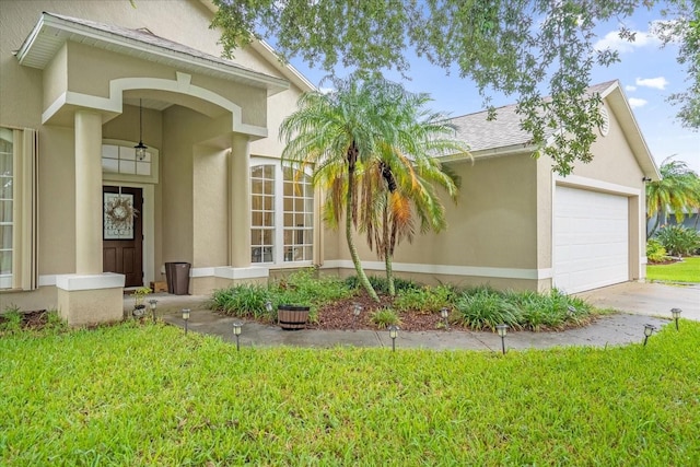 entrance to property with a yard and a garage