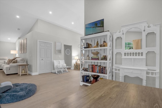 interior space with high vaulted ceiling and light hardwood / wood-style floors