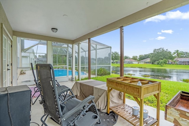 sunroom / solarium with a water view