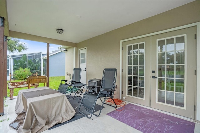 sunroom / solarium featuring a healthy amount of sunlight and french doors