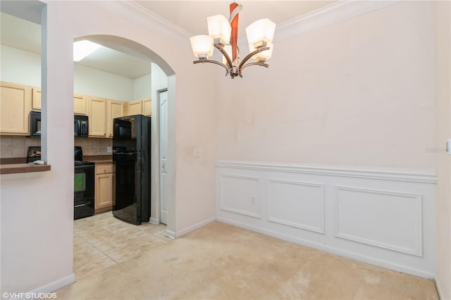 kitchen featuring backsplash, black appliances, crown molding, a notable chandelier, and light colored carpet