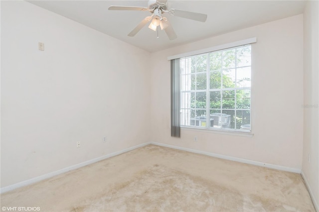 carpeted spare room featuring ceiling fan