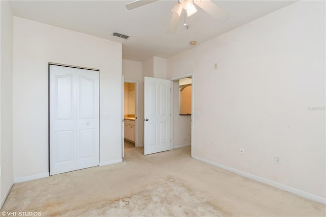 unfurnished bedroom featuring a closet, ceiling fan, and light colored carpet