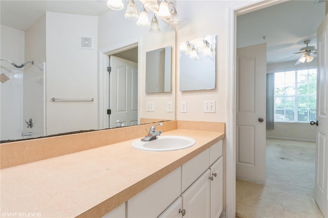 bathroom featuring vanity, ceiling fan, and walk in shower