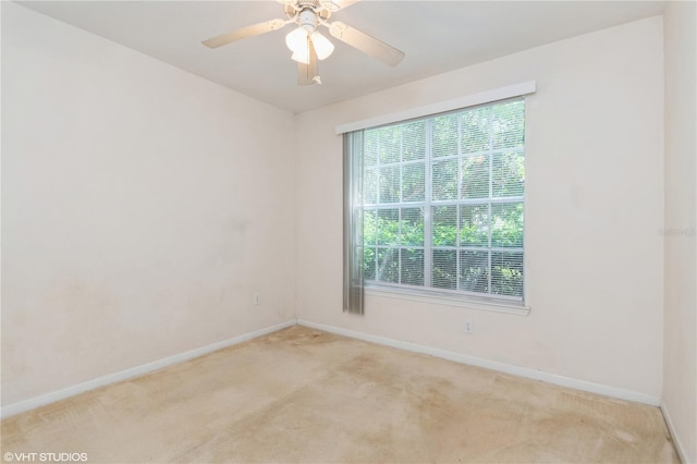 unfurnished room featuring light carpet and ceiling fan