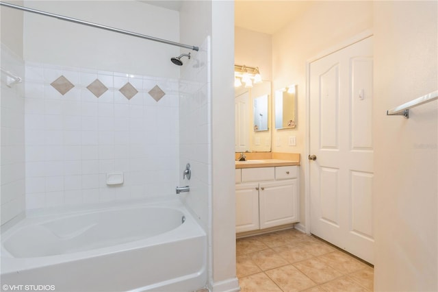 bathroom featuring vanity, tiled shower / bath, and tile patterned floors