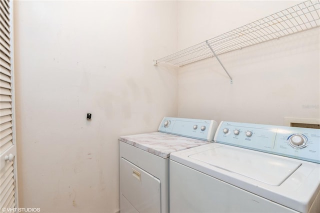 laundry area featuring washing machine and clothes dryer