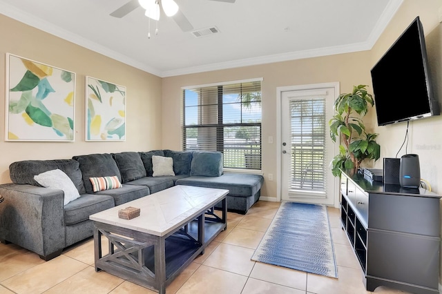 tiled living room with ornamental molding and ceiling fan