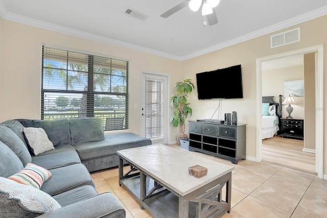 tiled living room featuring crown molding and ceiling fan