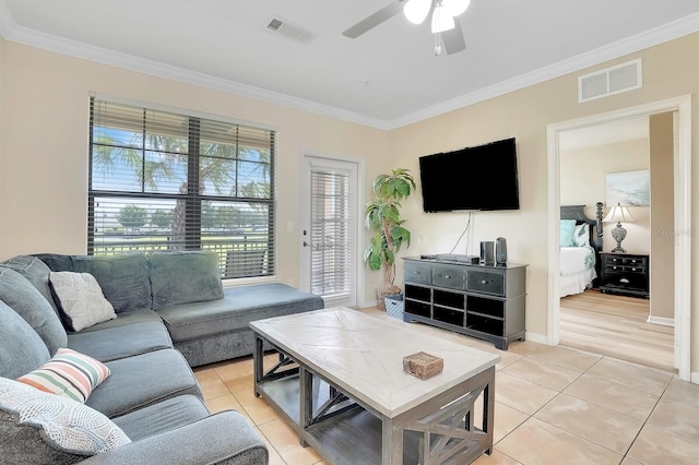 909 Charo Pkwy Unit 1021, Davenport, FL 33897 - living room with crown molding, light tile patterned floors, and a ceiling fan