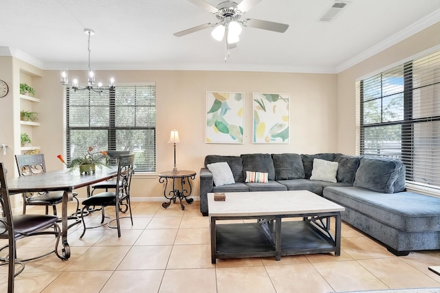 tiled living room with ceiling fan with notable chandelier and ornamental molding