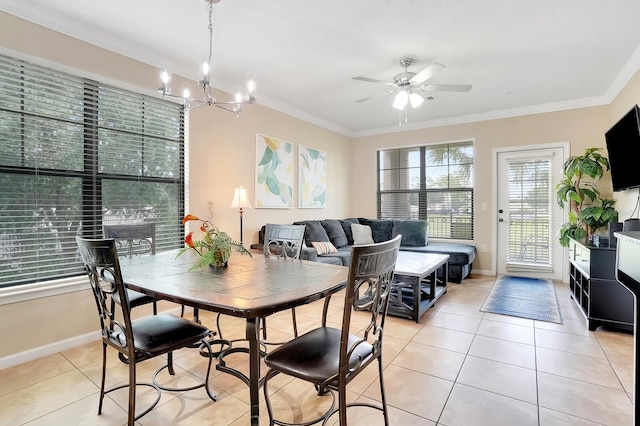 dining room with ceiling fan with notable chandelier, crown molding, and light tile patterned floors