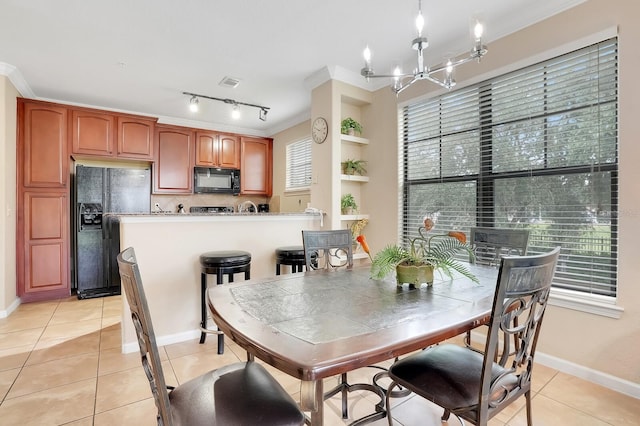 909 Charo Pkwy Unit 1021, Davenport, FL 33897 - dining space with a chandelier, light tile patterned flooring, and crown molding