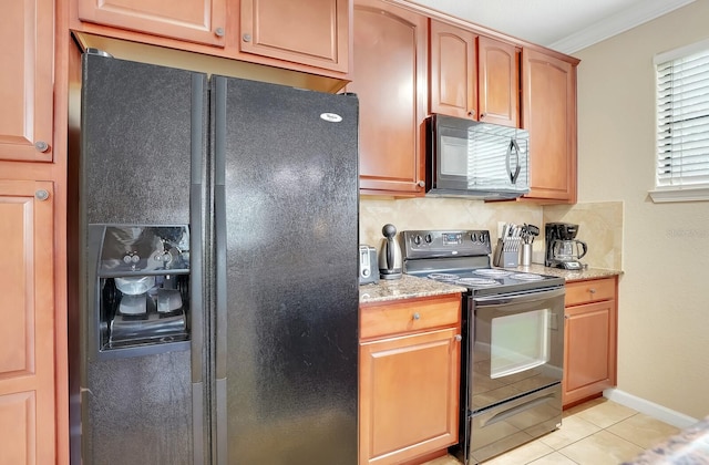 kitchen featuring decorative backsplash, light stone countertops, light tile patterned floors, black appliances, and crown molding