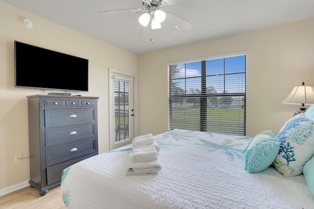 bedroom featuring ceiling fan, light wood-type flooring, and access to exterior