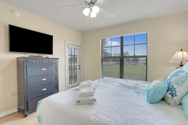 909 Charo Pkwy Unit 1021, Davenport, FL 33897 - bedroom with access to exterior, light wood finished floors, and ceiling fan