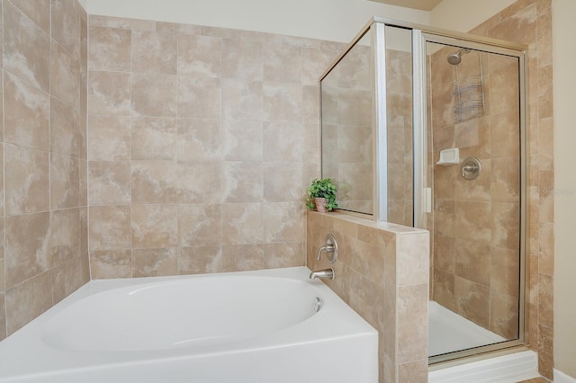 bathroom with separate shower and tub