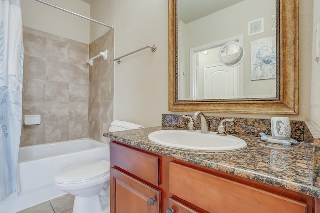 full bathroom featuring shower / bath combo with shower curtain, tile patterned floors, vanity, and toilet