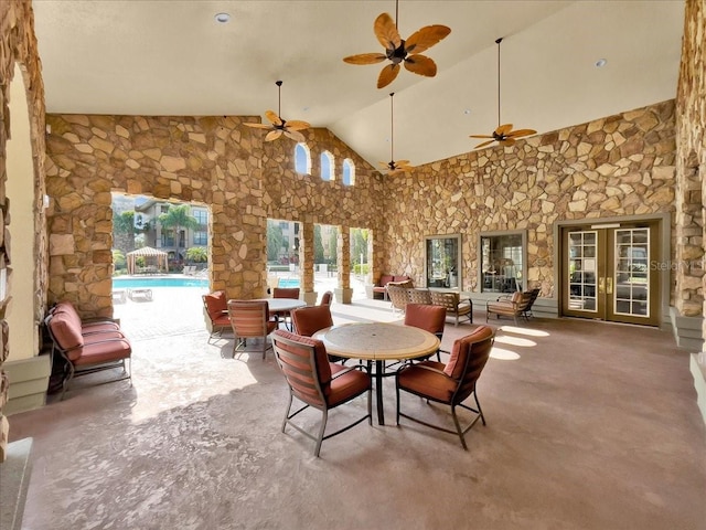 909 Charo Pkwy Unit 1021, Davenport, FL 33897 - view of patio / terrace with an indoor pool, ceiling fan, outdoor dining area, and french doors
