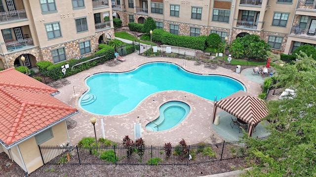 view of pool with a patio area and a hot tub