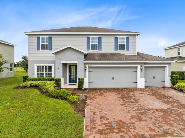 front facade with a garage and a front lawn