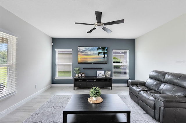 living room featuring light hardwood / wood-style floors and ceiling fan