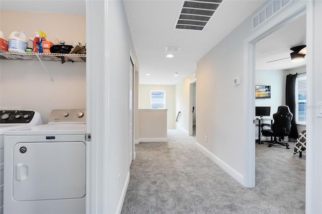 clothes washing area with light carpet, washing machine and clothes dryer, and ceiling fan