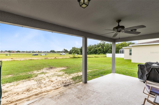 view of patio / terrace with ceiling fan and a rural view