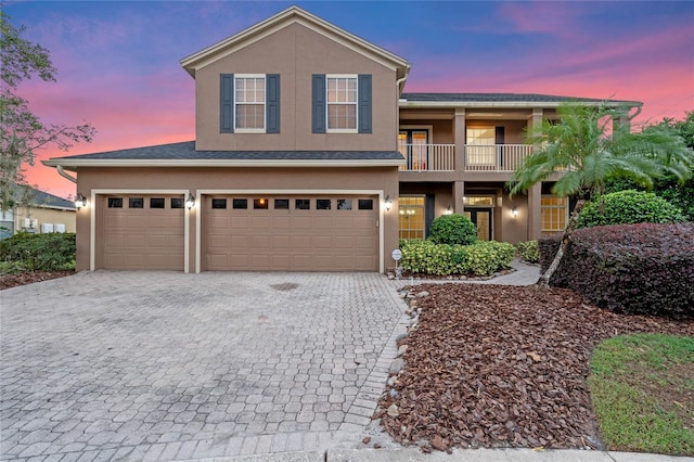 view of front of property with a balcony and a garage