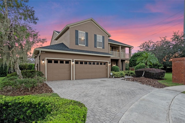 view of front of property with a balcony and a garage