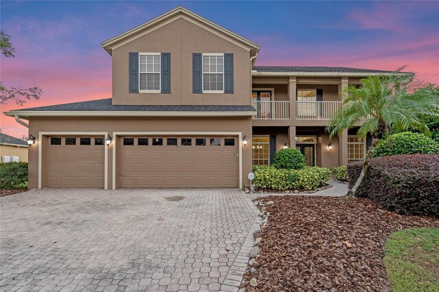 view of front of home with a balcony and a garage